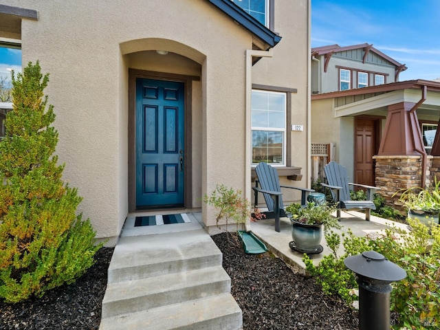 entrance to property with stucco siding