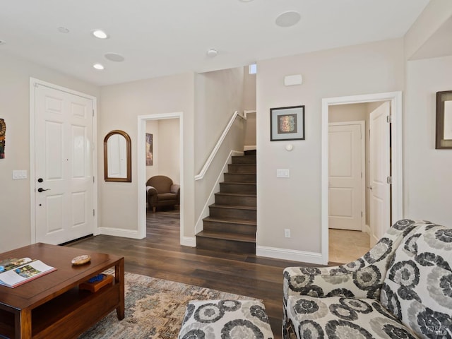 living room with recessed lighting, baseboards, wood finished floors, and stairs