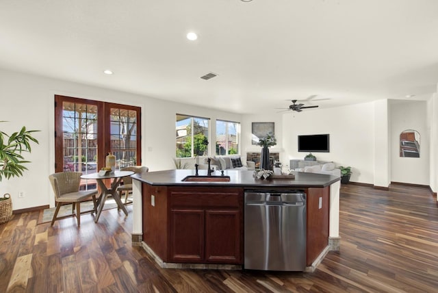 kitchen with visible vents, dark wood-type flooring, a sink, dark countertops, and dishwasher