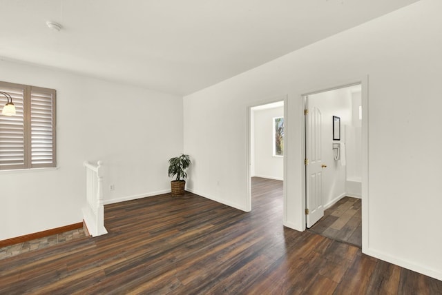 empty room with wood finished floors and baseboards