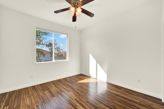 spare room featuring a ceiling fan, baseboards, and wood finished floors