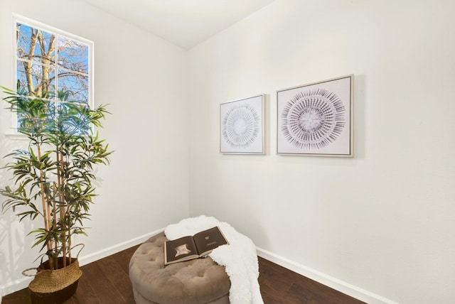 sitting room with wood finished floors and baseboards