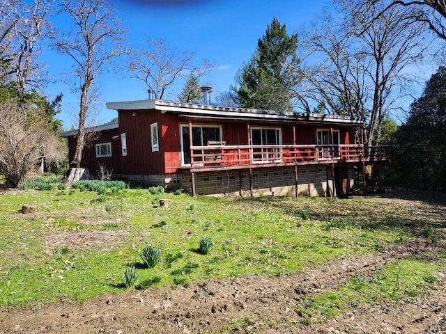 rear view of property featuring a wooden deck