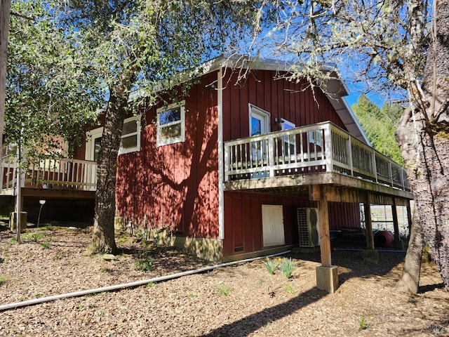 rear view of property with a wooden deck