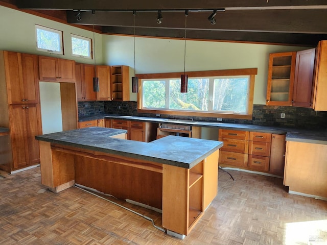 kitchen featuring decorative backsplash, brown cabinets, a center island, and open shelves