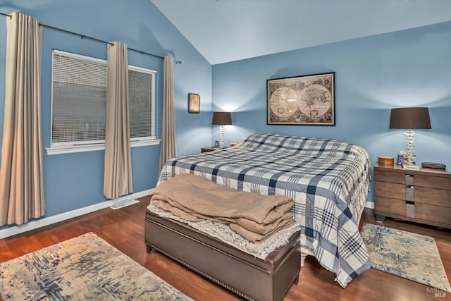 bedroom featuring lofted ceiling, wood finished floors, visible vents, and baseboards