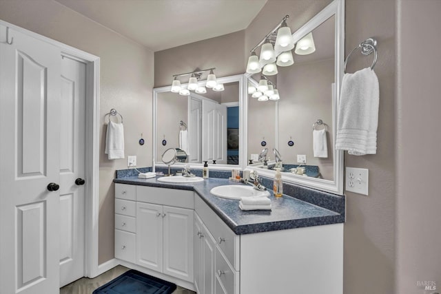 full bathroom with a sink and double vanity