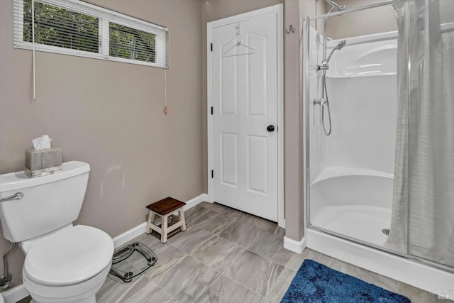 full bath with a shower stall, toilet, and baseboards