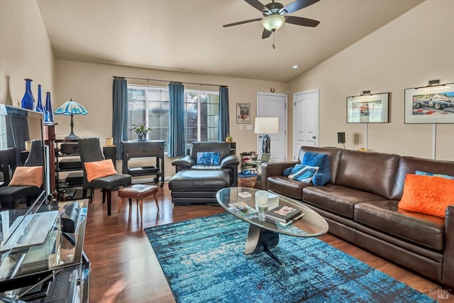 living area with dark wood finished floors, ceiling fan, and vaulted ceiling