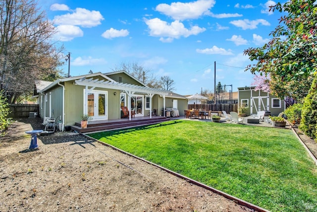 back of property featuring a pergola, a fenced backyard, an outdoor structure, a patio area, and a storage unit