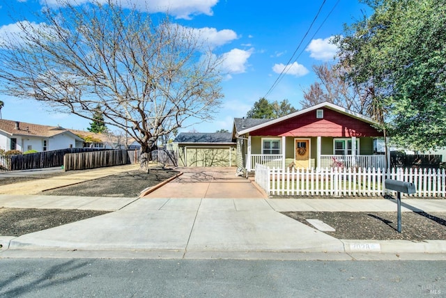 bungalow-style home featuring a fenced front yard and covered porch