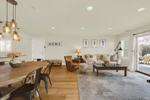 living room with recessed lighting, light wood-type flooring, and visible vents