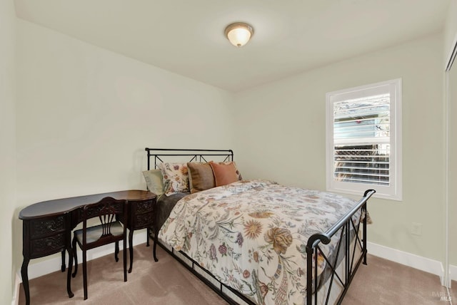 bedroom with carpet flooring and baseboards