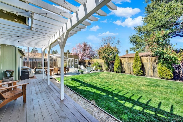 view of yard with a wooden deck, a patio area, a pergola, and a fenced backyard