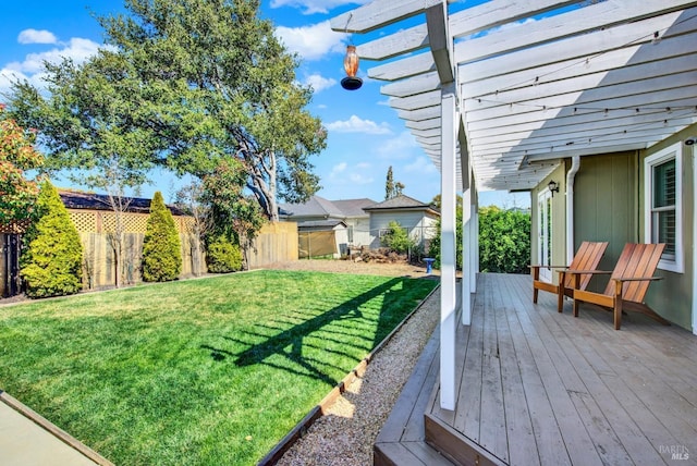 view of yard with fence, a deck, and a pergola