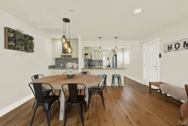 dining space with recessed lighting, baseboards, and dark wood-style flooring