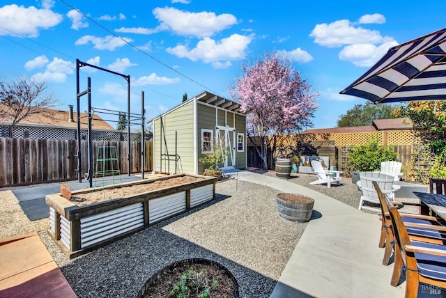 view of patio with an outbuilding and a fenced backyard