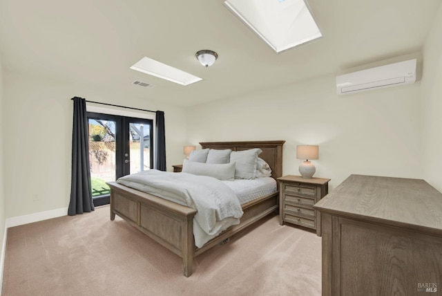 bedroom featuring visible vents, light colored carpet, a wall unit AC, a skylight, and access to outside