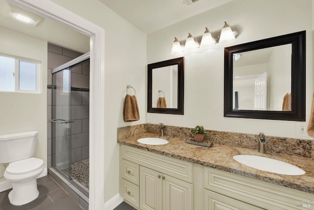 bathroom with a shower stall, toilet, double vanity, and a sink