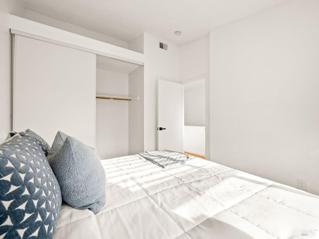 bedroom with a closet and visible vents