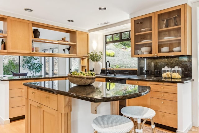 kitchen featuring visible vents, open shelves, dark stone countertops, a sink, and decorative backsplash