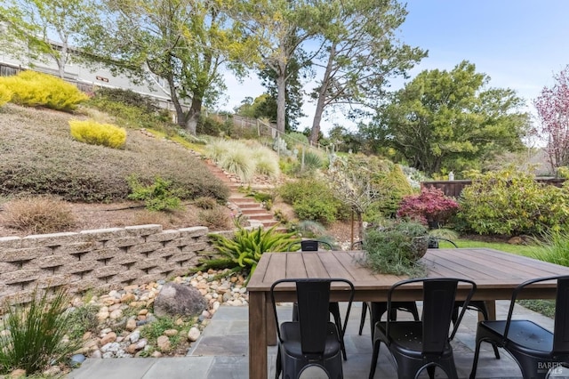 view of patio / terrace with outdoor dining space, stairs, and fence