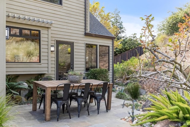 view of patio / terrace featuring outdoor dining space and fence