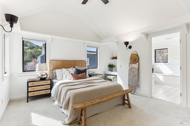 bedroom featuring connected bathroom, baseboards, ceiling fan, light colored carpet, and vaulted ceiling