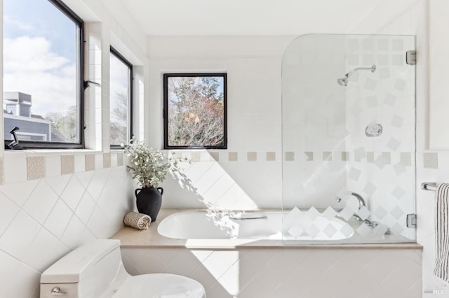 full bathroom with toilet, a bathtub, and tiled shower