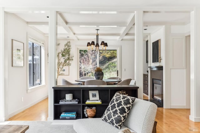 kitchen featuring a wealth of natural light, wood finished floors, and coffered ceiling