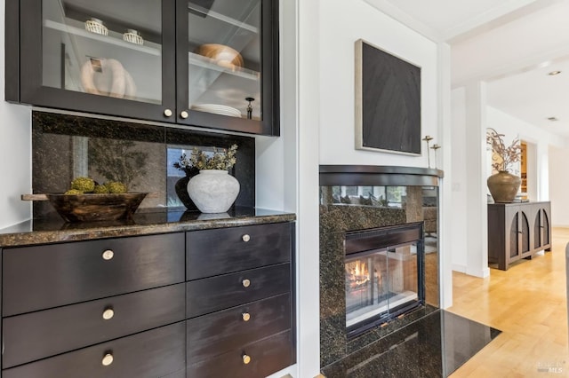 details featuring wood finished floors and a tile fireplace