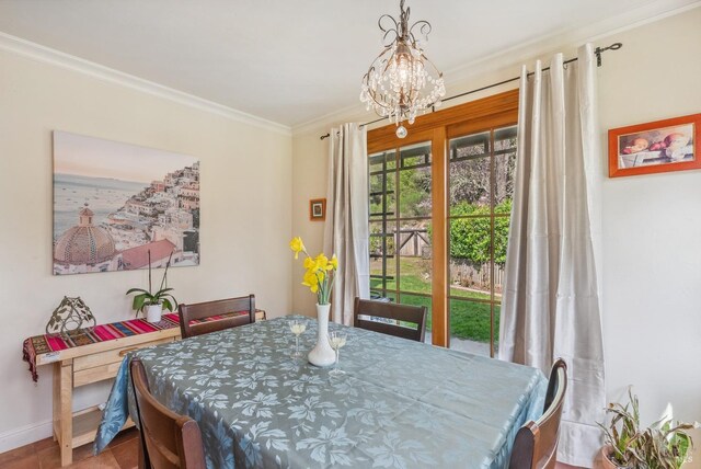 dining space with baseboards, an inviting chandelier, and ornamental molding