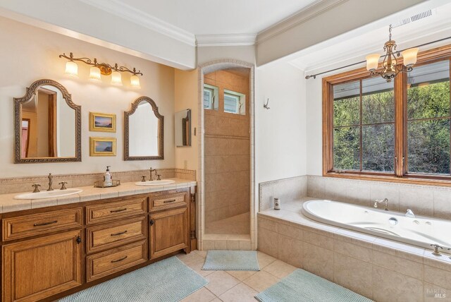 full bathroom featuring a garden tub, double vanity, a sink, ornamental molding, and tile patterned floors