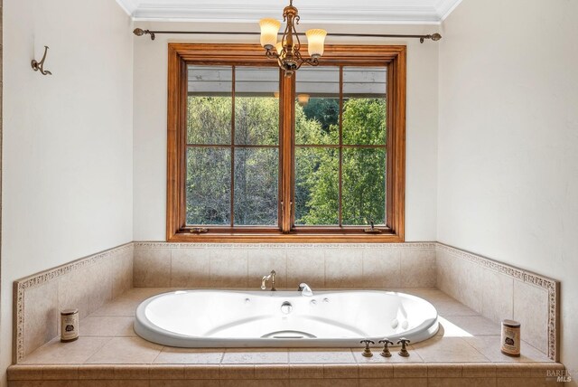 bathroom featuring a chandelier, ornamental molding, and a whirlpool tub