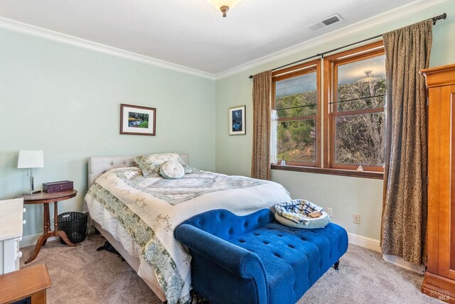 carpeted bedroom featuring crown molding, baseboards, and visible vents