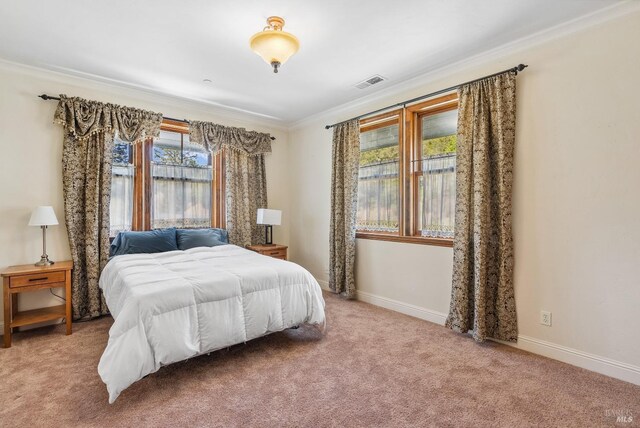 bedroom with light carpet, baseboards, visible vents, and ornamental molding