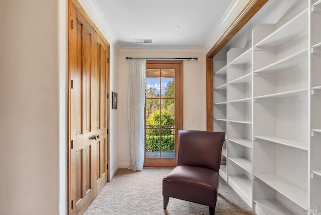 sitting room with visible vents, baseboards, carpet, and ornamental molding