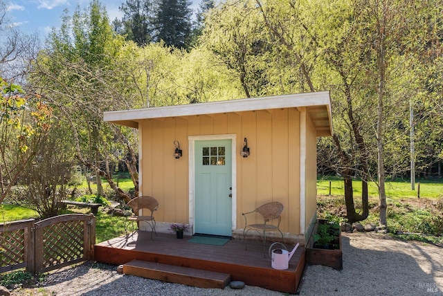 view of outbuilding with an outdoor structure and fence