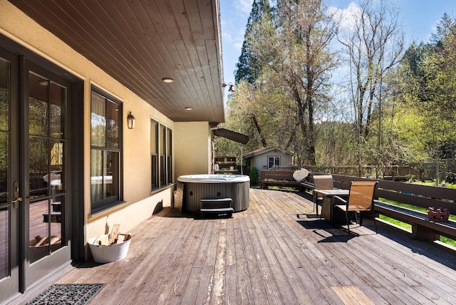 wooden terrace featuring central AC unit and a hot tub