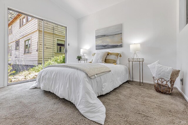 bedroom with carpet flooring, access to outside, baseboards, and vaulted ceiling