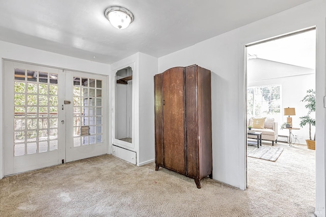 interior space with french doors and carpet flooring