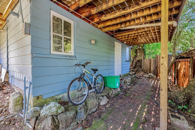 view of side of home featuring fence