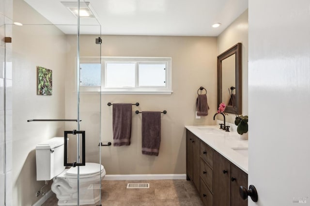 full bathroom with visible vents, toilet, a sink, a shower with door, and double vanity