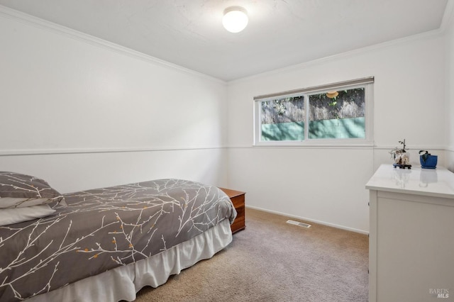 carpeted bedroom featuring baseboards and ornamental molding