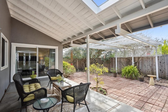 view of patio featuring a pergola and fence