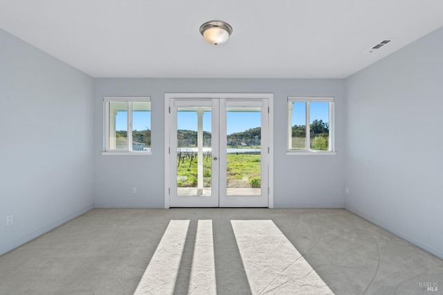 interior space featuring visible vents, a healthy amount of sunlight, french doors, and baseboards