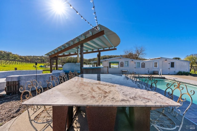 view of patio / terrace featuring a fenced in pool and outdoor dry bar