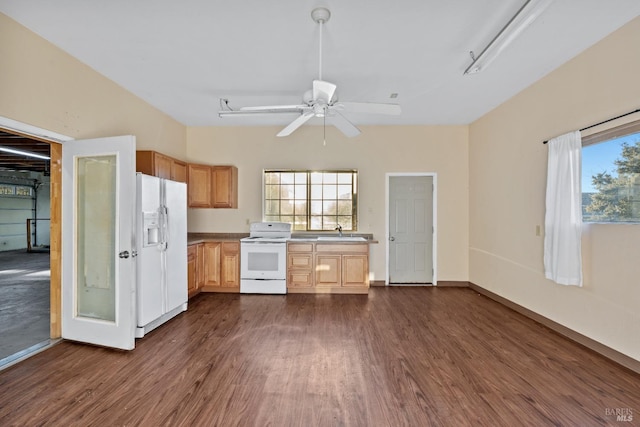 kitchen with a ceiling fan, white appliances, dark wood-style floors, and a sink