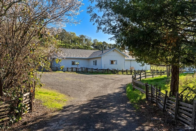 view of home's exterior with driveway and fence