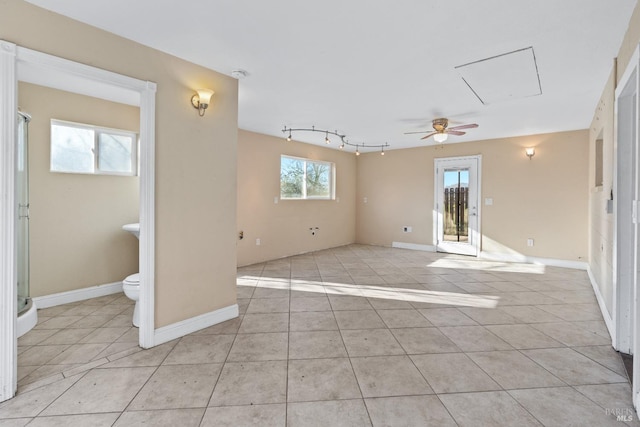 empty room with light tile patterned flooring, baseboards, and ceiling fan